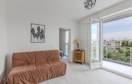 ein Wohnzimmer mit einer Couch und einer Glasschiebetür in der Unterkunft 1 Bedroom Awesome Apartment In Royan in Royan