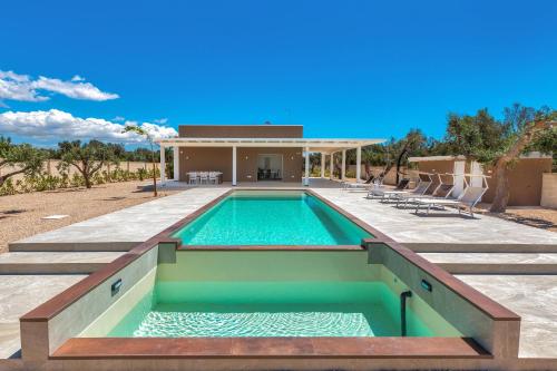 a swimming pool in front of a house at Sinfonia delle Onde by Perle di Puglia in San Pietro in Bevagna