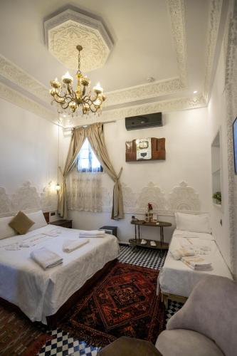 Postel nebo postele na pokoji v ubytování Palais Shazam & SPA