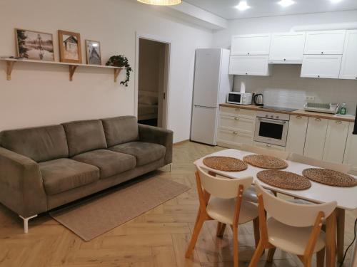 a living room with a couch and a table and chairs at Sweet home 1 in Cahul