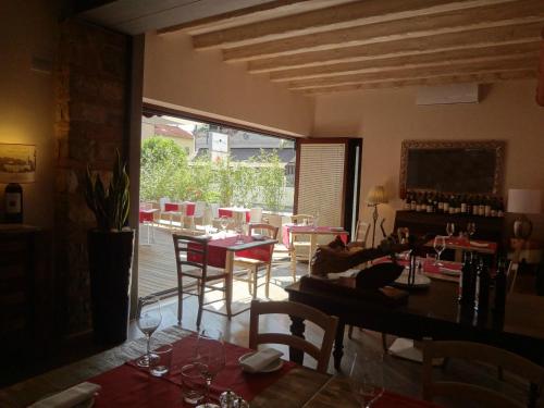 a dining room with a table and chairs and a large window at Hotel Noce in Brescia