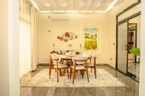 a dining room with a table and chairs at Résidence La Perle - Yaoundé in Yaoundé