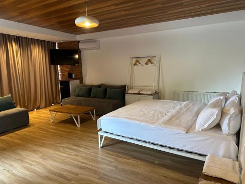 a bedroom with a bed and a couch at Chiko Group in Aspindza