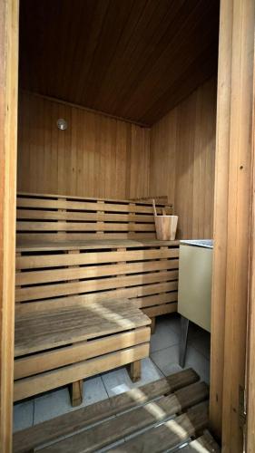 a sauna with a bench in a wooden room at Gardi Hotel & Suites in Buenos Aires