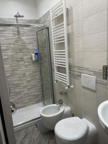 a bathroom with a shower and a toilet and a sink at Casa Argegno in Argegno