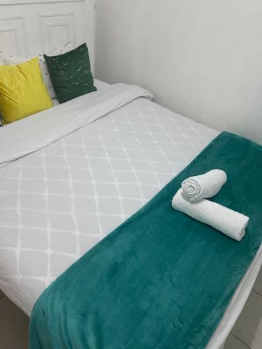 a bed with two towels sitting on top of it at Bella Homes Thika Town in Thika