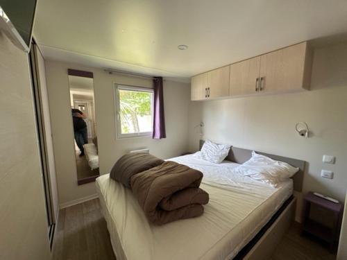 - une chambre avec un lit et des couvertures dans l'établissement Le Clos des Soulacaises, à Soulac-sur-Mer