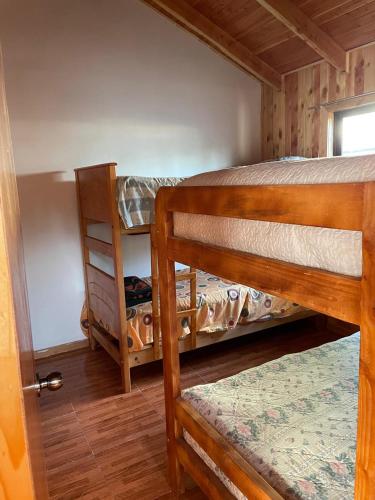 a bedroom with two bunk beds in a cabin at Cabaña para 6 personas in Licán Ray
