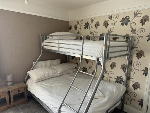 a bedroom with two bunk beds in a room at Clacton Guest House in Clacton-on-Sea