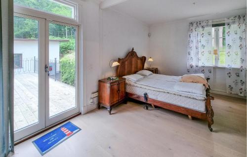 a bedroom with a bed and a large window at Cozy Apartment In Alingsås in Alingsås
