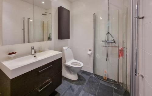 a bathroom with a sink and a toilet and a shower at Cozy Apartment In Alingsås in Alingsås