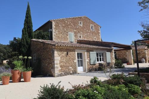 an old stone house with a white door at Gite Monet in Bouchet
