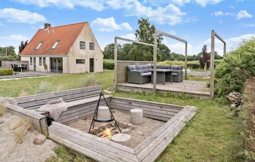 a backyard with a fire pit and a house at Cozy Home In Haderslev With Wifi in Haderslev