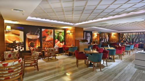 a restaurant with colorful chairs and tables in a room at Park Inn by Radisson Istanbul Asia Kavacik in Istanbul