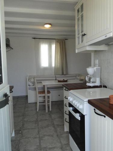 a kitchen with a counter and a table in it at Mike'sPlace in Antiparos Town