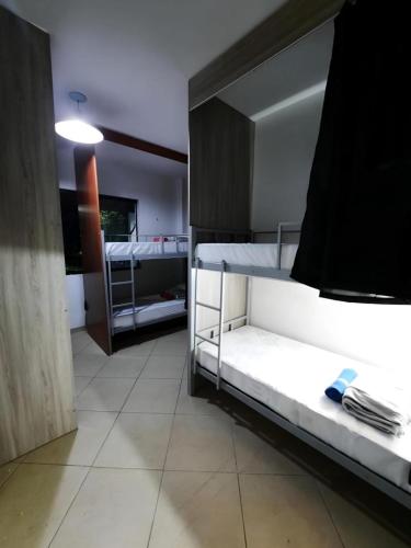 a room with two bunk beds and a mirror at Soul do Mar Hostel in Cabo Frio