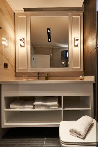 a bathroom with a sink and a mirror at Edem Villa Park in Agva