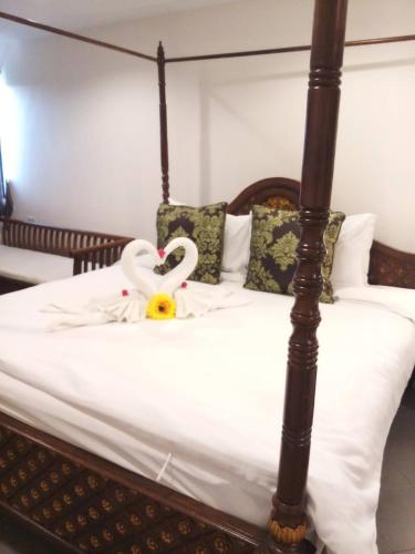 a bed with a heart made out of towels at The Guest Hotel & Hostel in Chiang Mai