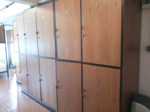 a row of wooden lockers in a room at The Guest Hotel & Hostel in Chiang Mai