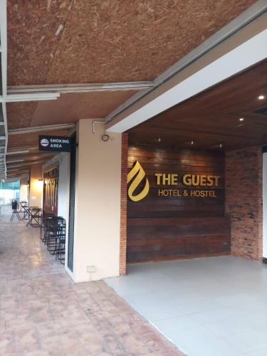 a sign on the wall of a hotel and hospital at The Guest Hotel & Hostel in Chiang Mai