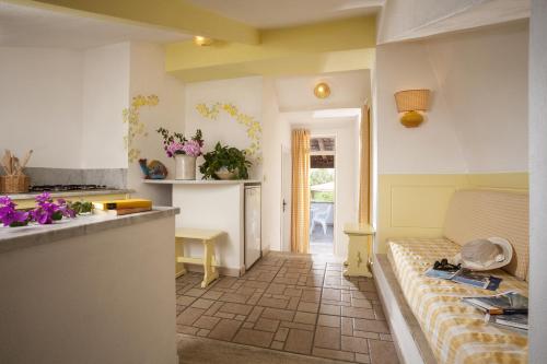 a kitchen with a couch in the middle of a room at Le Roccette Club in Tropea
