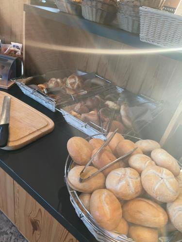 a counter with a bunch of loaves of bread at Hotel Zum Bären in Kurort Altenberg