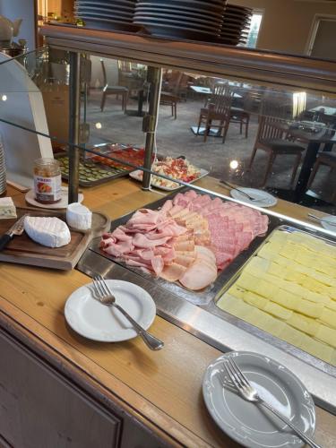 a buffet with meats and cheese on a table at Hotel Zum Bären in Kurort Altenberg