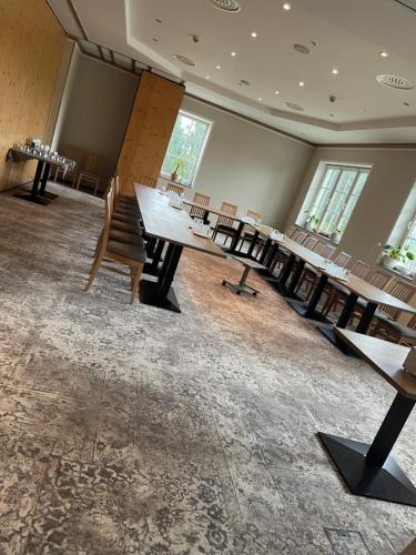a large room with tables and chairs in it at Hotel Zum Bären in Kurort Altenberg
