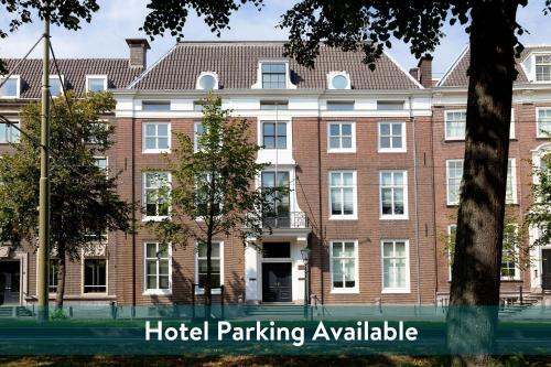 a large brick building with the hotel parking available at Staybridge Suites The Hague - Parliament by IHG in The Hague