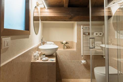 a bathroom with a sink and a toilet at Osteria Luxury Apartments in Peschiera del Garda