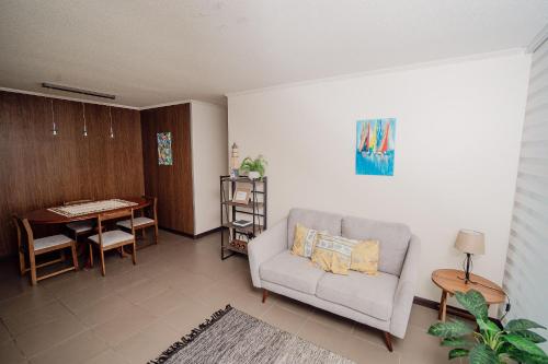 a living room with a couch and a table at Hermoso departamento en primeria línea in Iquique