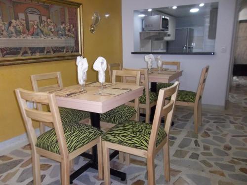 a dining room with a table and four chairs at Casa Jac in Bucaramanga
