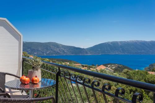 a table with pumpkins on a balcony with a view of the water at Alexanna Studio Apartments in Matsoukáta