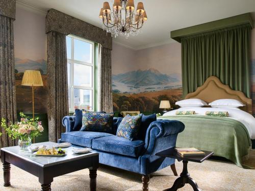 a bedroom with a blue couch and a bed at The Killarney Park in Killarney