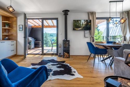 a living room with a blue couch and a wood stove at Chata Kloučka Stříbrná Skalice in Stříbrná Skalice