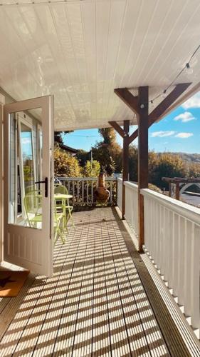 a porch of a house with a glass door at Couples Escape - Summerhouse cabin with hot tub and stunning views in Truro