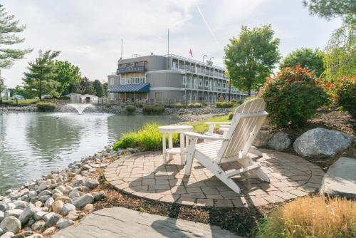 two white chairs sitting in front of a building at Fulton Steamboat Inn in Lancaster