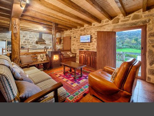 a living room with a couch and a table at Casa Alagoa in Castro Laboreiro