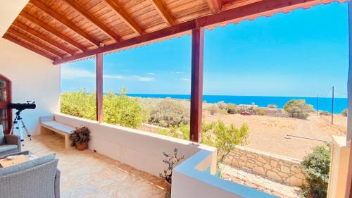 a view of the ocean from a house with a large window at Orionas in Tsoútsouros