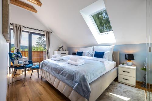 a bedroom with a large bed and a window at Chata Kloučka Stříbrná Skalice in Stříbrná Skalice