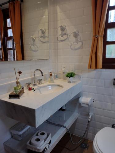 a bathroom with a sink and a toilet at Chalé Recanto Bela Vista in Monte Verde