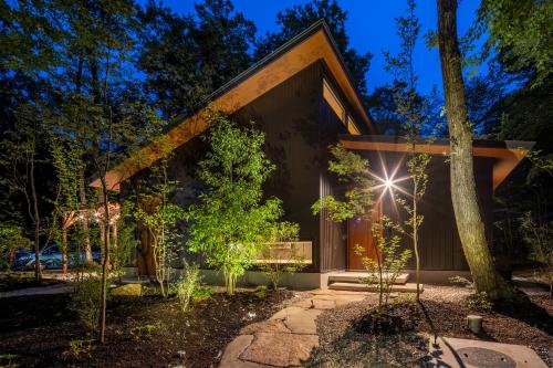a house in the woods at night at 森の宿り 時庵 まるやま in Nasu