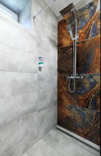 a bathroom with a shower with a shower head at APARTMÁNY Sninský dvor in Snina