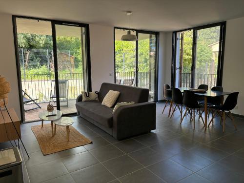 a living room with a couch and a table at Appartement Bormes in Bormes-les-Mimosas