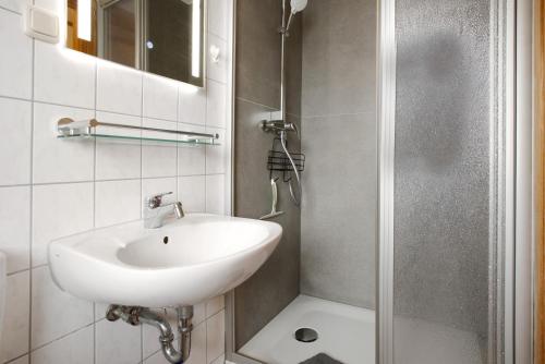 a bathroom with a sink and a shower at Haus Albatros Wohnung 4 in Ostseebad Koserow