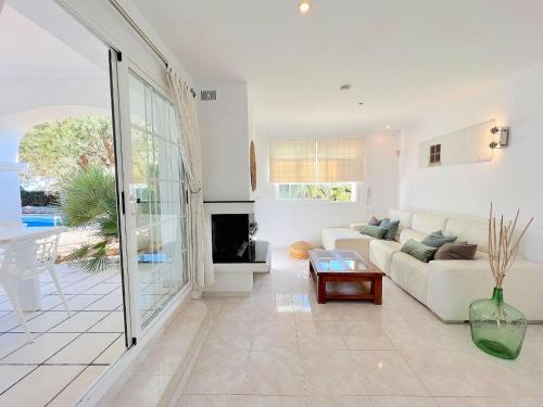 a living room with a couch and a table at INIBIZA VILLAS - Villa Oasis in Sant Jordi