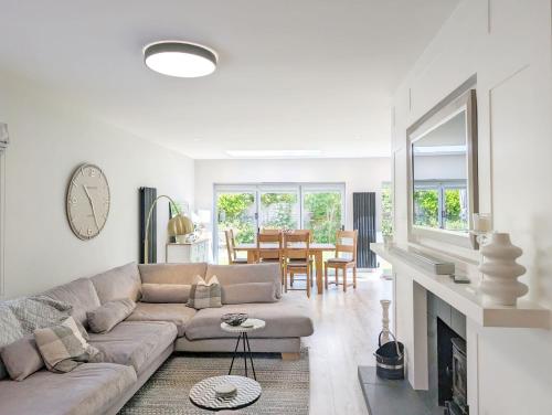 a living room with a couch and a fireplace at One Elms Way - Sleeps 8 - West Wittering in West Wittering