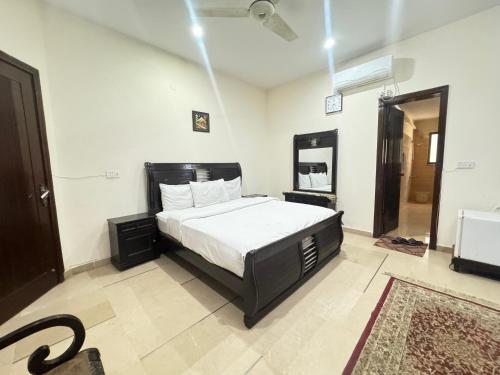 a bedroom with a large bed in a room at Millat Guest House F10-4 in Islamabad