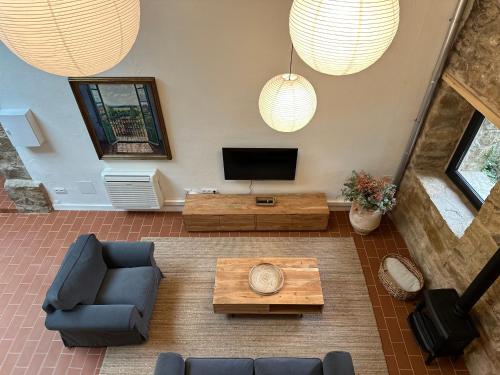 a living room with a tv and a couch and a table at Encís d'Empordà -Adults Only- in Casavells