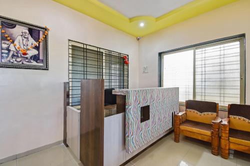 a waiting room with a table and chairs and a window at SPOT ON Hotel Sai Jeeva Residency in Shirdi